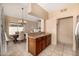 Kitchen with wood cabinets, breakfast bar, and open access to the dining area with a chandelier and large windows at 4212 W Jason Dr, Glendale, AZ 85308