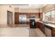 Efficient kitchen with wood cabinets, stainless steel appliances, tile backsplash, and ample counter space at 4212 W Jason Dr, Glendale, AZ 85308