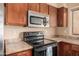 The kitchen has a black range and microwave, complemented by dark cabinetry at 4212 W Jason Dr, Glendale, AZ 85308