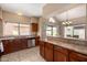 Open-concept kitchen with warm wood cabinetry, breakfast bar, and easy access to the adjacent dining area and large windows at 4212 W Jason Dr, Glendale, AZ 85308