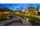 Backyard showcasing a pool, lush lawn, covered patio, and stone paver walkway at 4223 N St Elias --, Mesa, AZ 85215