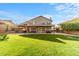 Expansive backyard featuring a covered patio, built-in bar, lush lawn, and charming string lights at 4223 N St Elias --, Mesa, AZ 85215