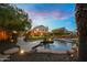 Backyard featuring a pool with a water feature, lush landscaping, and stone paver walkway at 4223 N St Elias --, Mesa, AZ 85215