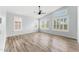Bright bedroom with hardwood floors, a ceiling fan, and large windows for natural light at 4223 N St Elias --, Mesa, AZ 85215