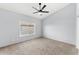 Calm bedroom with neutral carpeting, ceiling fan, and a view to the outside at 4223 N St Elias --, Mesa, AZ 85215