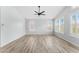 Bright bedroom with two windows, wood-look floors, and modern ceiling fan creating a comfortable retreat at 4223 N St Elias --, Mesa, AZ 85215