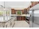 Well-equipped kitchen featuring stainless steel appliances, granite countertops, and dark wood cabinetry at 4223 N St Elias --, Mesa, AZ 85215