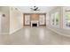 Spacious living room featuring tile floors, a ceiling fan, and a cozy fireplace at 4223 N St Elias --, Mesa, AZ 85215