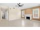 Bright living room boasts tile floors, modern ceiling fan, and a charming fireplace at 4223 N St Elias --, Mesa, AZ 85215