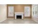 Comfortable living room featuring tile flooring and a classic fireplace with window views at 4223 N St Elias --, Mesa, AZ 85215