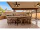 Entertainers outdoor kitchen featuring stone accents, granite counters, bar seating, and large grill at 4223 N St Elias --, Mesa, AZ 85215