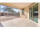 Relaxing back patio with covered area, tiled floors, offering serene outdoor living space at 4360 N 186Th Ln, Goodyear, AZ 85395