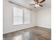 Bright bedroom features wood-look floors, ceiling fan, and sunlit windows at 4360 N 186Th Ln, Goodyear, AZ 85395