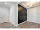 Elegant entryway with modern black accent wall and light hardwood flooring at 4360 N 186Th Ln, Goodyear, AZ 85395