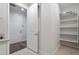 Hallway offers a view of a laundry area with shelving, white trim, and light gray walls at 4360 N 186Th Ln, Goodyear, AZ 85395