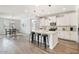 Open-concept kitchen with quartz countertops, island, and stainless steel appliances at 4360 N 186Th Ln, Goodyear, AZ 85395