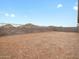 A large, empty backyard space with block wall fencing and mountain views in the background at 4777 W Hunter Trl, San Tan Valley, AZ 85144