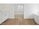 Bright bathroom featuring wood-look tile floors and entrance to bedroom at 4777 W Hunter Trl, San Tan Valley, AZ 85144