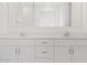 Close-up of bright bathroom featuring double sinks and white cabinets at 4777 W Hunter Trl, San Tan Valley, AZ 85144
