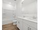 A bright bathroom with a double sink vanity, white cabinets, and a shower-tub combo at 4777 W Hunter Trl, San Tan Valley, AZ 85144