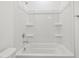 Clean, bright bathroom showcasing white acrylic shower-tub with built-in shelving at 4777 W Hunter Trl, San Tan Valley, AZ 85144