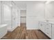 Bathroom with dual sinks, glass enclosed shower, and wood-style tile flooring at 4777 W Hunter Trl, San Tan Valley, AZ 85144
