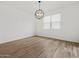 Bedroom with decorative light fixture, window and wood-look tile flooring at 4777 W Hunter Trl, San Tan Valley, AZ 85144