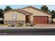 Charming single-story home with a two-car garage and a well-maintained desert front yard with low stone accents at 4777 W Hunter Trl, San Tan Valley, AZ 85144