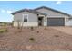 Single-story home showcasing neutral paint, low-maintenance landscaping, and a convenient two-car garage at 4777 W Hunter Trl, San Tan Valley, AZ 85144
