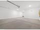 Spacious two-car garage featuring sealed concrete flooring and modern lighting at 4777 W Hunter Trl, San Tan Valley, AZ 85144