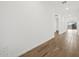 Bright hallway featuring sleek wood-look flooring and fresh white paint at 4777 W Hunter Trl, San Tan Valley, AZ 85144