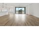 Bright living room with wood-look tile flooring and sliding glass doors showcasing mountain views at 4777 W Hunter Trl, San Tan Valley, AZ 85144