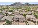 Aerial view of neighborhood showcasing beautiful landscaping, tile roofs, and gorgeous mountain views at 5557 W Mine Trl, Phoenix, AZ 85083