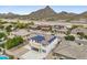 Aerial view of neighborhood showcasing beautiful landscaping, tile roofs, and gorgeous mountain views at 5557 W Mine Trl, Phoenix, AZ 85083