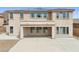 Rear of home featuring large covered patio with view of multiple windows and beautiful desert landscape at 5557 W Mine Trl, Phoenix, AZ 85083