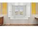 Bathroom featuring a soaking tub surrounded by white walls and built-in shelving at 5557 W Mine Trl, Phoenix, AZ 85083
