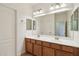 Bathroom with a large mirror, double sinks and wood cabinets at 5557 W Mine Trl, Phoenix, AZ 85083