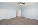Bedroom with gray carpet, ceiling fan, and doorway to an additional room at 5557 W Mine Trl, Phoenix, AZ 85083