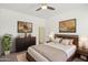 Comfortable bedroom with modern furniture, stylish artwork, and neutral color palette at 5557 W Mine Trl, Phoenix, AZ 85083