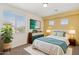 Cozy bedroom with large window, soft bedding, and stylish decor at 5557 W Mine Trl, Phoenix, AZ 85083