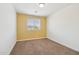 Bedroom featuring yellow accent wall, plush carpet, and ample natural light at 5557 W Mine Trl, Phoenix, AZ 85083
