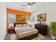 Vibrant bedroom with bright accent wall, modern furniture, and natural light at 5557 W Mine Trl, Phoenix, AZ 85083