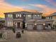 Charming home with appealing stonework, driveway, multi-car garage, and lovely sunset at 5557 W Mine Trl, Phoenix, AZ 85083