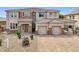 Beautiful two-story house with stone accents, tile roof, and a paver driveway at 5557 W Mine Trl, Phoenix, AZ 85083