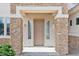 Elegant front entryway featuring a stone facade, stylish sidelights, and a neutral-colored door at 5557 W Mine Trl, Phoenix, AZ 85083
