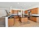 Spacious kitchen with stainless steel appliances, wood cabinets, black granite countertops, and tile floors at 5557 W Mine Trl, Phoenix, AZ 85083