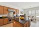 Well-equipped kitchen featuring stainless steel range and center island with dark countertops at 5557 W Mine Trl, Phoenix, AZ 85083