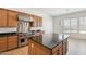 Spacious kitchen featuring center island, stainless hood, and plenty of natural light at 5557 W Mine Trl, Phoenix, AZ 85083