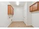 Laundry room with tile floor, storage cabinets, and washer and dryer hookups at 5557 W Mine Trl, Phoenix, AZ 85083