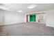 Spacious living room featuring neutral carpet, open layout, and staircase access at 5557 W Mine Trl, Phoenix, AZ 85083